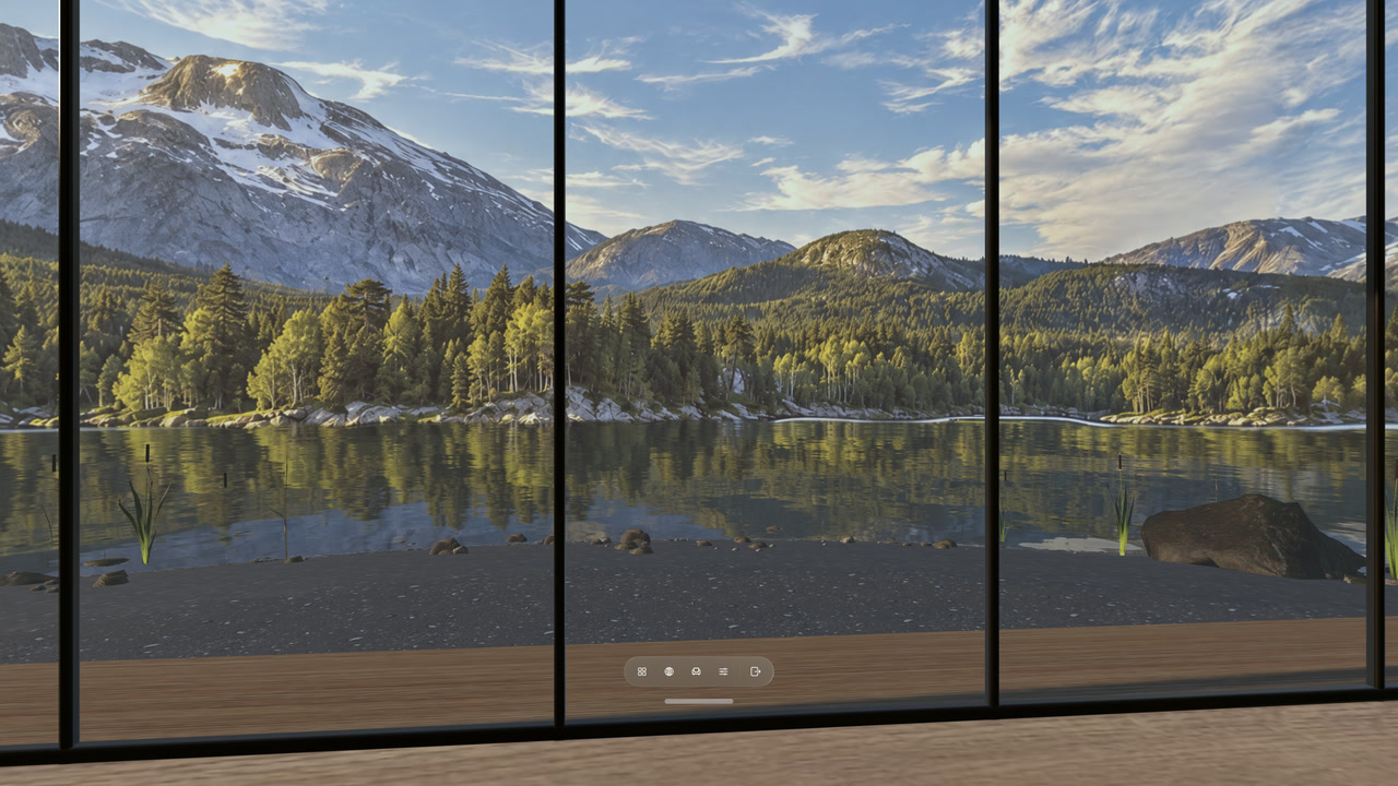 Mountain reflections on lake water beyond the windows of a Locus Room