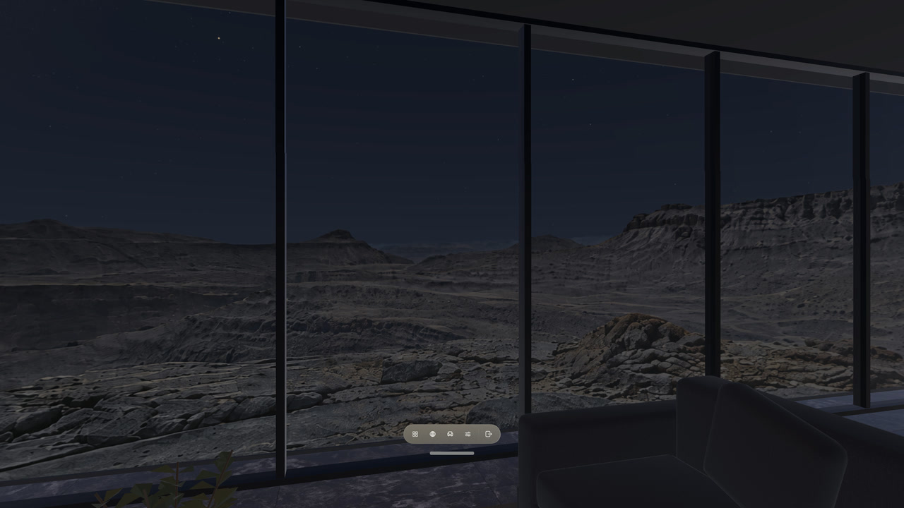 A night sky and rocky landscape beyond the glass walls of Skyline Office