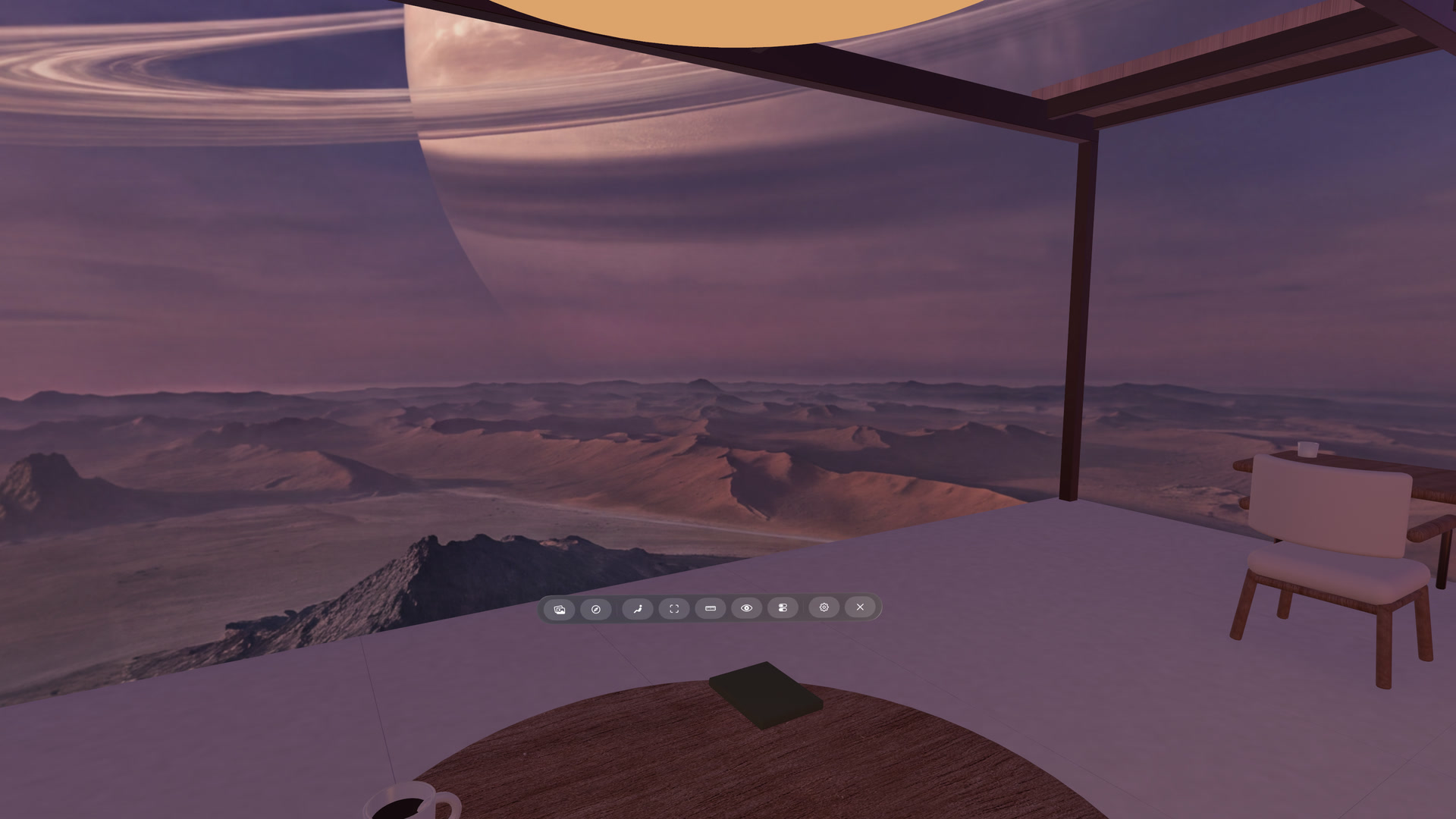 A ringed planet above mountains outside Winter Garden, with a table and chair inside